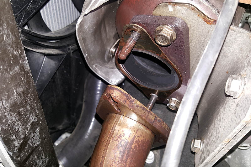 Unbolting the exhaust from the downpipe is simple, and makes installing the insert easy